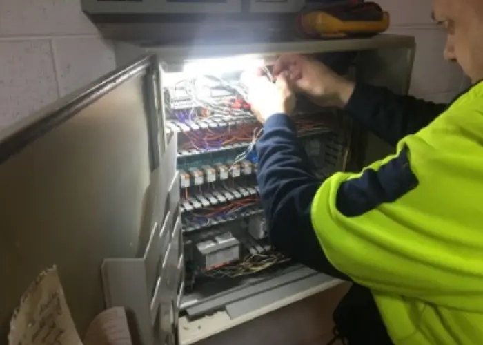 Electrician working on electrical panel
