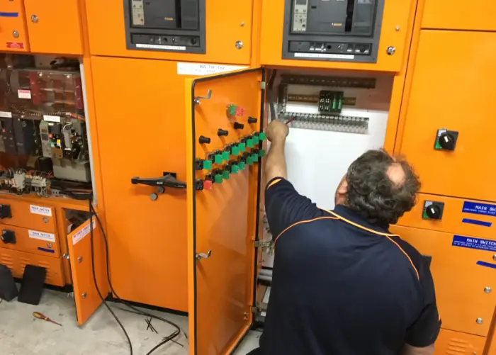 Electrician working on electrical panel